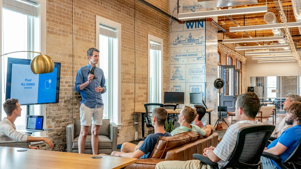 Team meeting in a bright brick-walled office